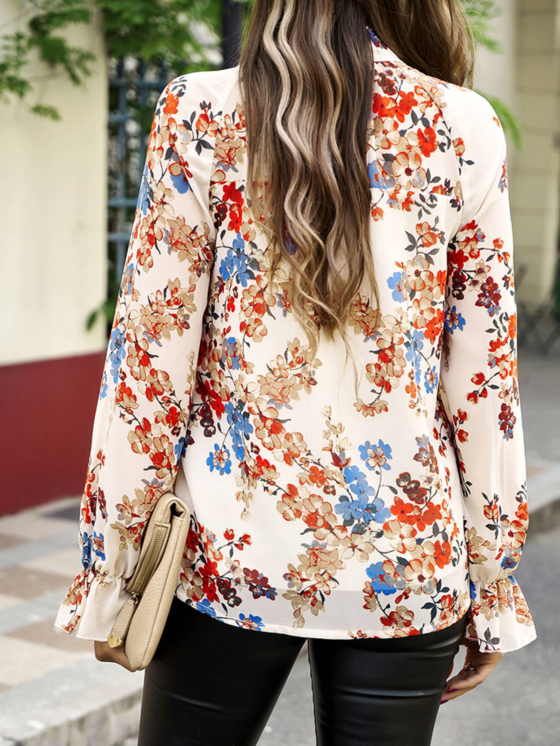 Elegant floral blue long-sleeved shirt for women by wholesalesir, featuring a colorful floral pattern and classic long sleeve design.