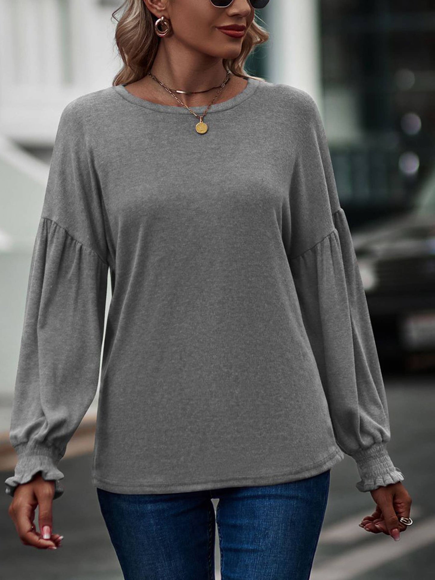 Beige long sleeve women's top with round neck, pleated details, and lantern sleeves from wholesalesir.