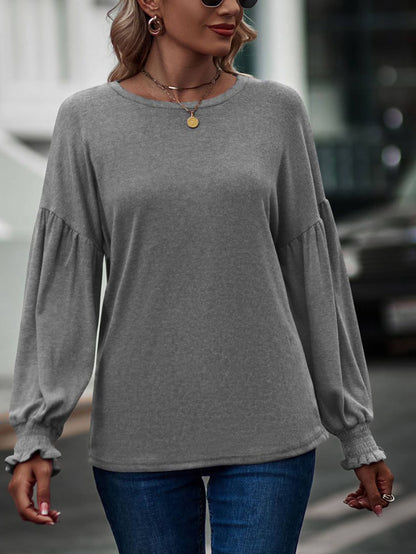 Beige long sleeve women's top with round neck, pleated details, and lantern sleeves from wholesalesir.