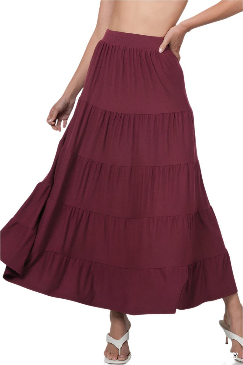 Small black Zenana elastic waist tiered ruffle maxi skirt displayed with flowing fabric and layered ruffle details.