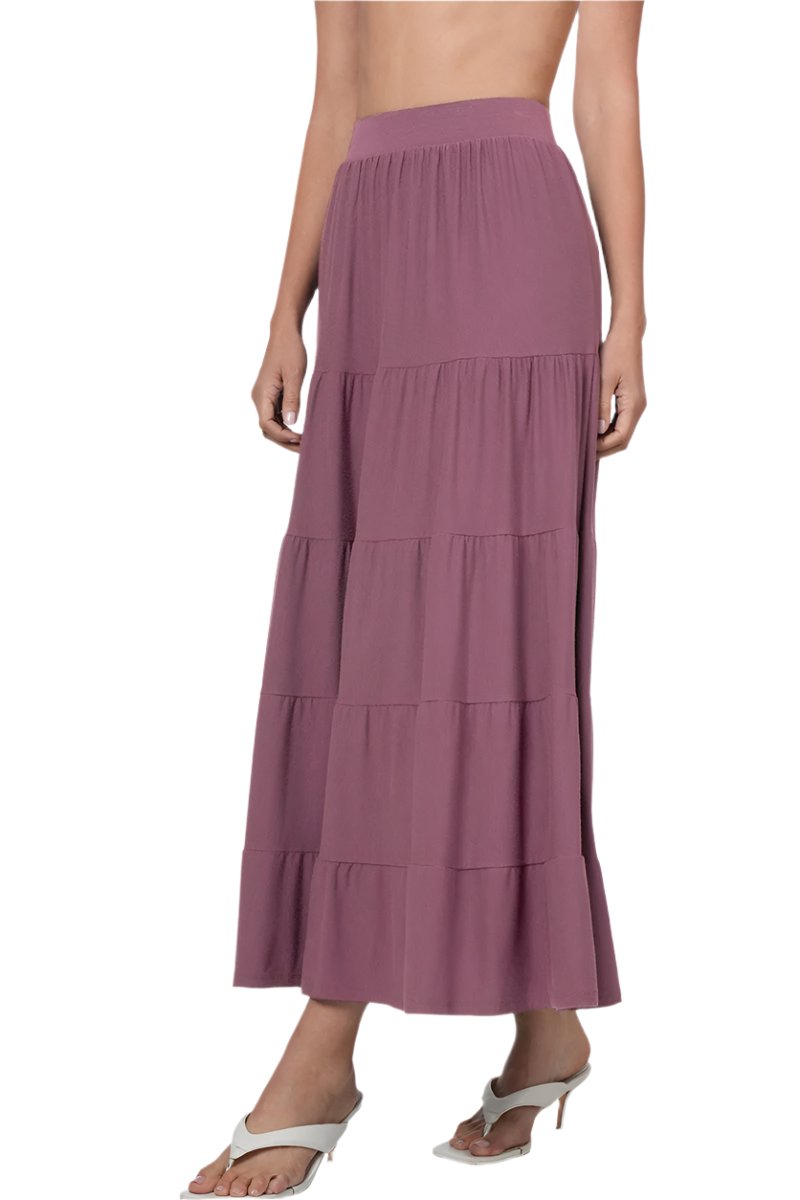 Black Zenana elastic waist tiered ruffle maxi skirt displayed on a small mannequin. Flowing fabric with layered ruffles.